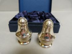 A pair of boxed hallmarked silver salt and pepper shakers