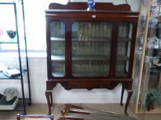 A mahogany display cabinet on cabriole legs