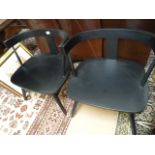 A pair of black lounge chairs