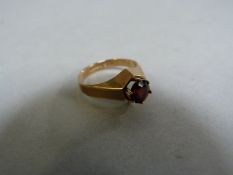A garnet ring set on 9ct gold- size K 1/2, total weight 2.8g