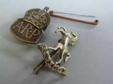 A 9ct gold tie clip ( pin not gold- total weight 1.4g), a silver ARP badge and one other