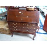 A modern bureau inlaid with brass detailing on stand with cabriole legs