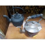 A cast iron kettle and a copper kettle