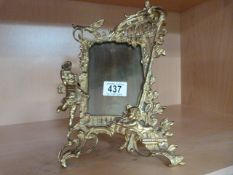An ornate brass photo frame marked "Harcourt" with registration number