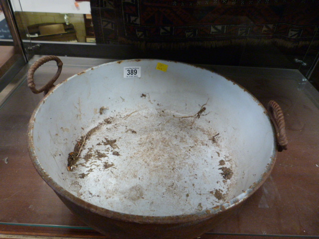 A cast iron two handled bowl