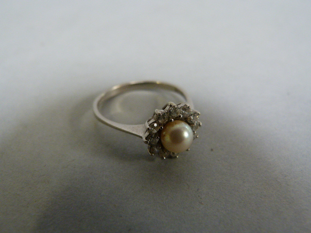 A pearl and diamond cluster ring set in 9ct white gold. size M 1/2, total weight 2.2g