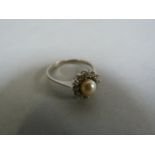 A pearl and diamond cluster ring set in 9ct white gold. size M 1/2, total weight 2.2g