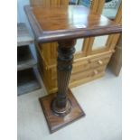 A Mahogany plant stand on carved stem