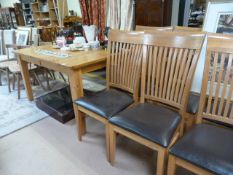 A light oak extending dining table and 6 chairs