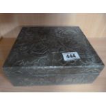 A pewter box decorated with flowers