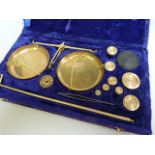 A cased set of brass scales