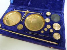 A cased set of brass scales