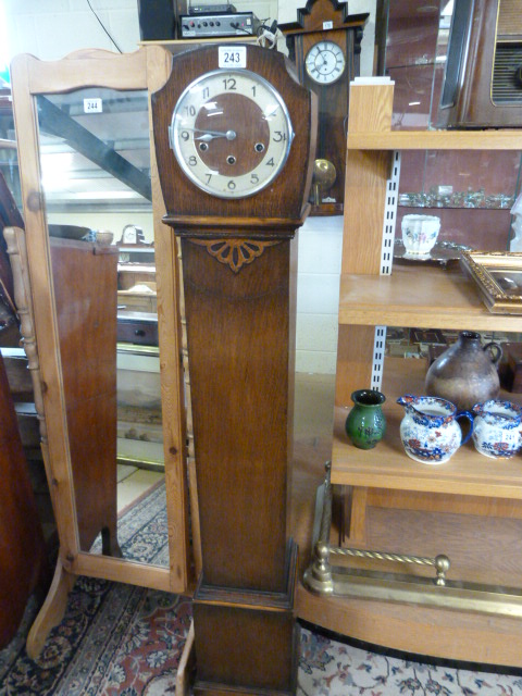 A Westminster chime grandmother clock in oak case- pendulum in office