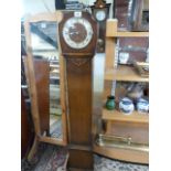 A Westminster chime grandmother clock in oak case- pendulum in office