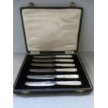 A cased set of fruit knives with mother of pearl handles and hallmarked silver blades