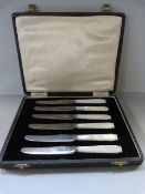 A cased set of fruit knives with mother of pearl handles and hallmarked silver blades