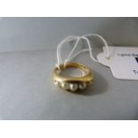 A 9ct gold ring with 5 seed pearls - total weight 5.7g