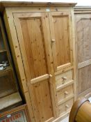 A Pine wardrobe with three drawers