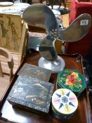 A quantity of various tins and a metal fan
