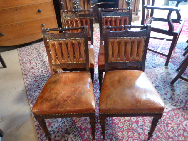 A Set of four leather upholstered dining chairs