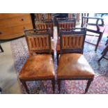 A Set of four leather upholstered dining chairs