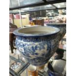 A blue and white Chinese fishbowl, decorated with mandarin ducks, lotus flowers etc.
