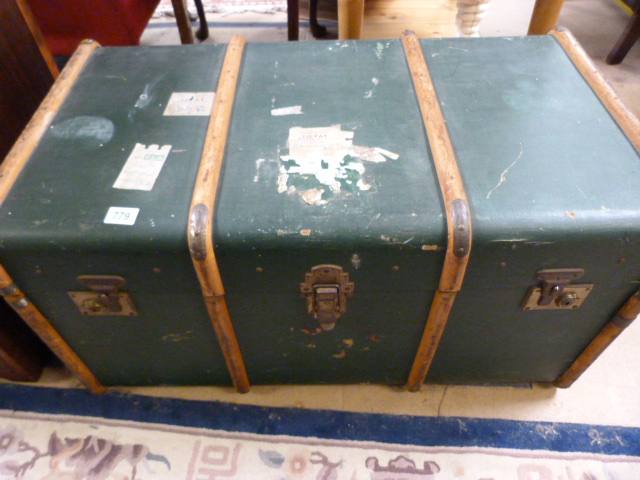 A large wooden bound steamer trunk