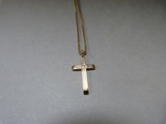 A 9ct gold cross on 9ct chain - weight 5.6