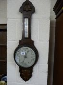 An oak carved aneroid barometer