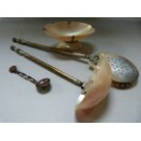 A mother of pearl ladle, strainer and a salt