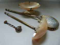 A mother of pearl ladle, strainer and a salt