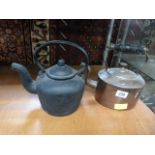 A cast iron kettle and a copper kettle