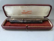 A Sampson Morden silver coloured propelling pencil and a hallmarked silver pencil