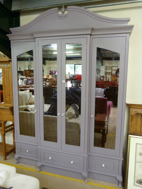 A large grey storage unit with mirrored doors