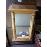A small pine mirror with shelf under