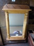 A small pine mirror with shelf under