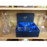 A pair of swirl decanters, a ship decanter and a boxed whiskey decanter with glaases