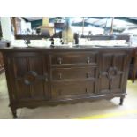 A Burmese teak sideboard with two cupboards and three drawers