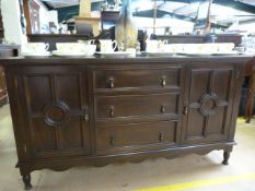 A Burmese teak sideboard with two cupboards and three drawers