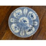 A Japanese blue and white charger with seal mark to base- hairline crack and nibbles to rim