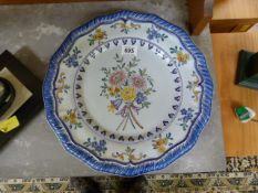 A large handpainted charger in the Delft style