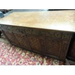 An antique carved oak coffer