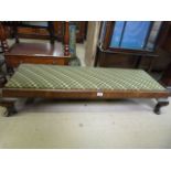 A long low upholstered mahogany footstool