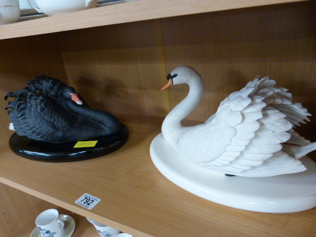 Two Franklin Mint swans on plinths - one black one white