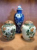 A pair of Famille Verte ginger jars and covers - covers both A/F and hairline crack to one jar.