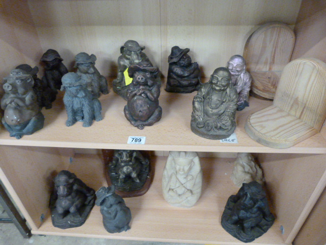 A large quantity of Resin figures on two shelves