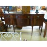 An inlaid serpentine sideboard