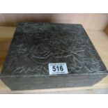 A pewter box decorated with flowers