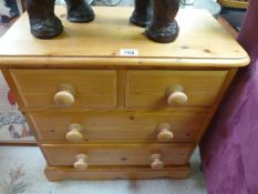 A small pine chest of four drawers
