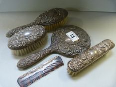 A hallmarked part dressing table set, consisting of a mirror and two brushes, along with a similar